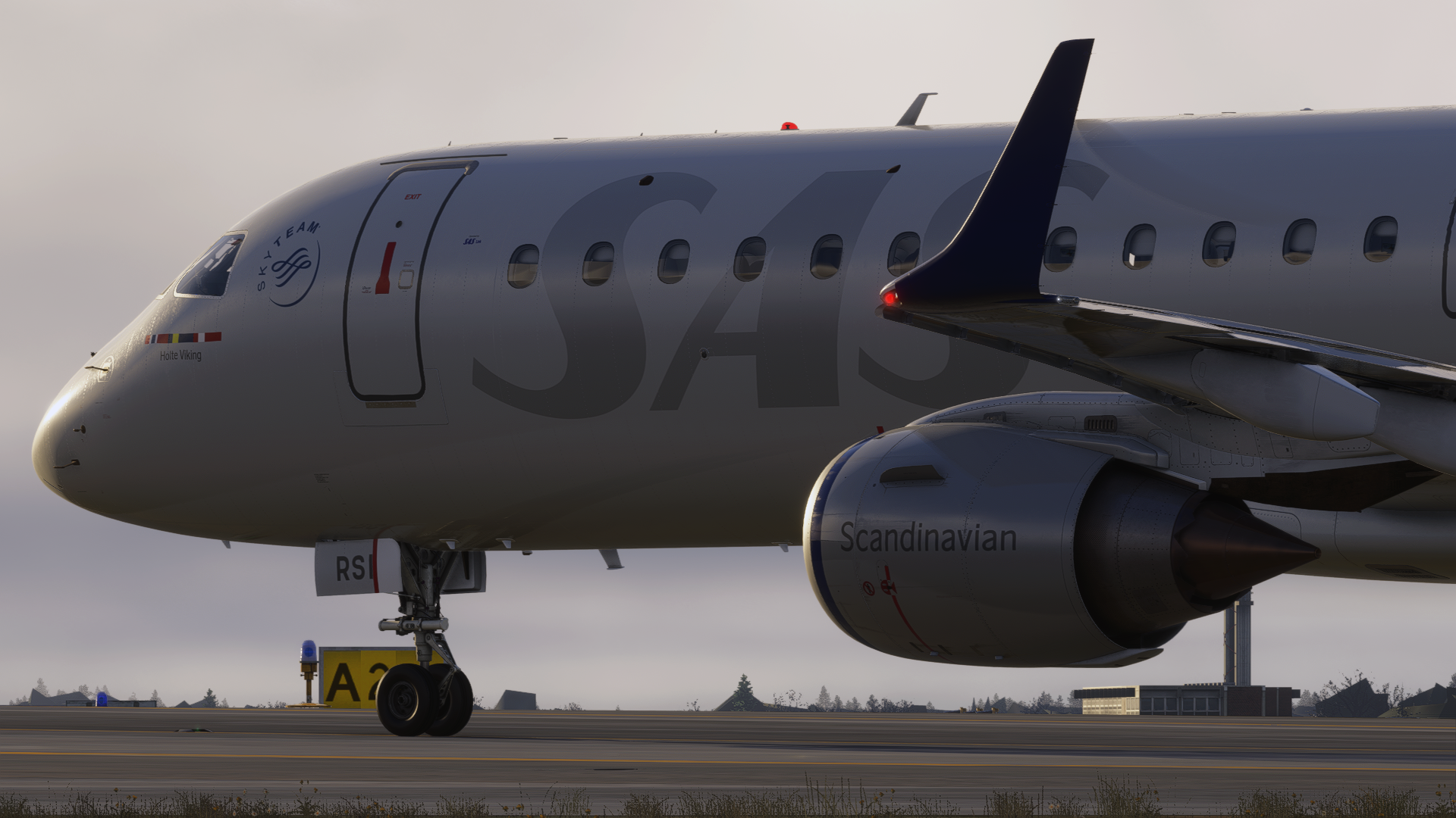 Close-up of a SAS Embraer on the ramp at dusk
