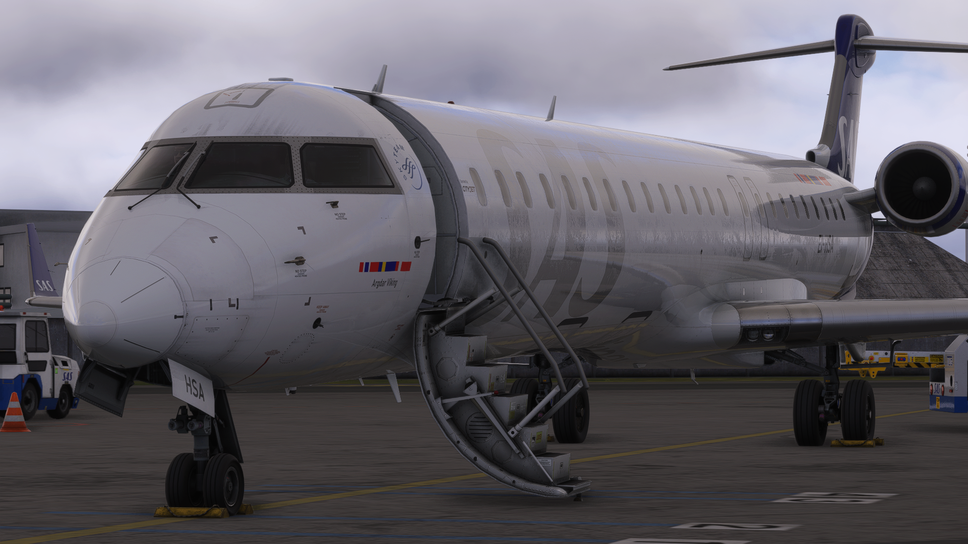 SAS CRJ parked at the stand with the cabin door open